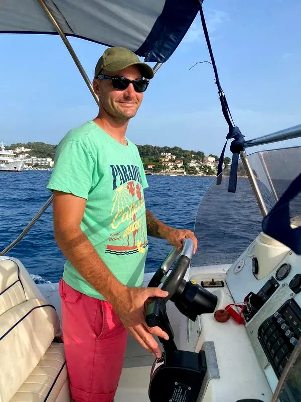 Jan at the helm with Hvar harbour behind him