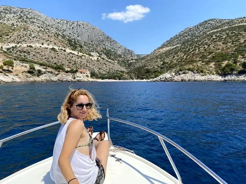 Viktorija on the bow approaching a hidden bay