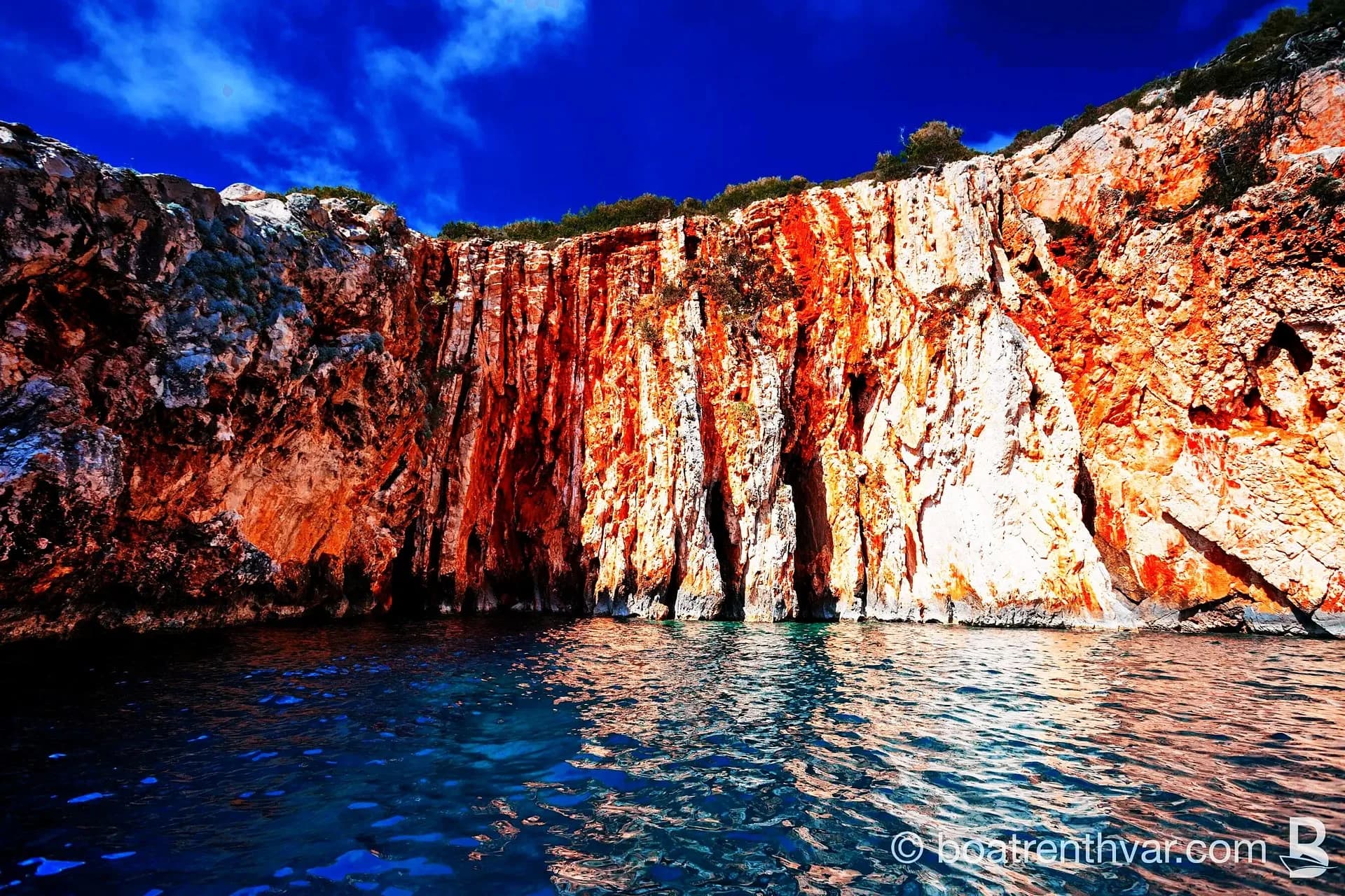 Dramatic red cliffs on a boat tour near Hvar
